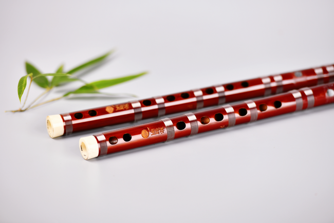 Guo Xinming Dizi - Premium Performance model with ox bone tips, showcasing rich red bamboo body and silver joint rings for precise tone.