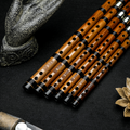 Close-up of Guo Xinming Professional Dizi flutes highlighting finger holes, tuning joints, and polished bamboo finish for advanced woodwind players.