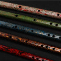 Close-up of Guo Xinming Daqi Special Edition Dizi flutes with intricate colored lacquer layers, highlighting texture and woodwind artistry.