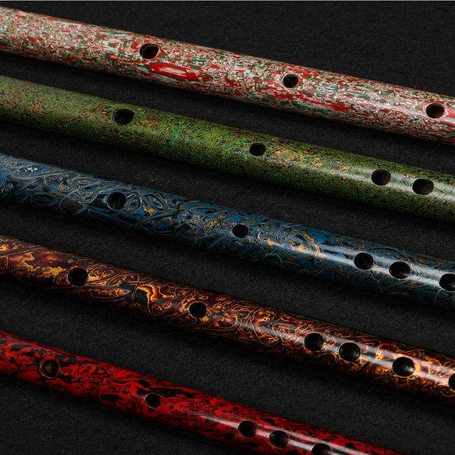 Close-up of Guo Xinming Daqi Special Edition Dizi flutes with intricate colored lacquer layers, highlighting texture and woodwind artistry.